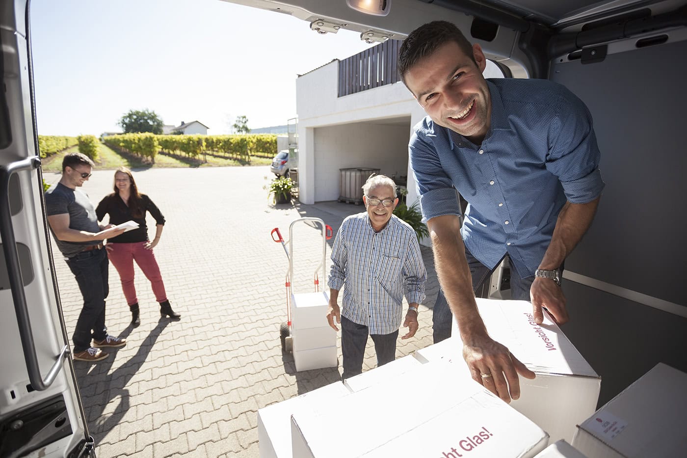 Mann beim Auspacken von Glaslieferung, professionelle Eventfotografie.